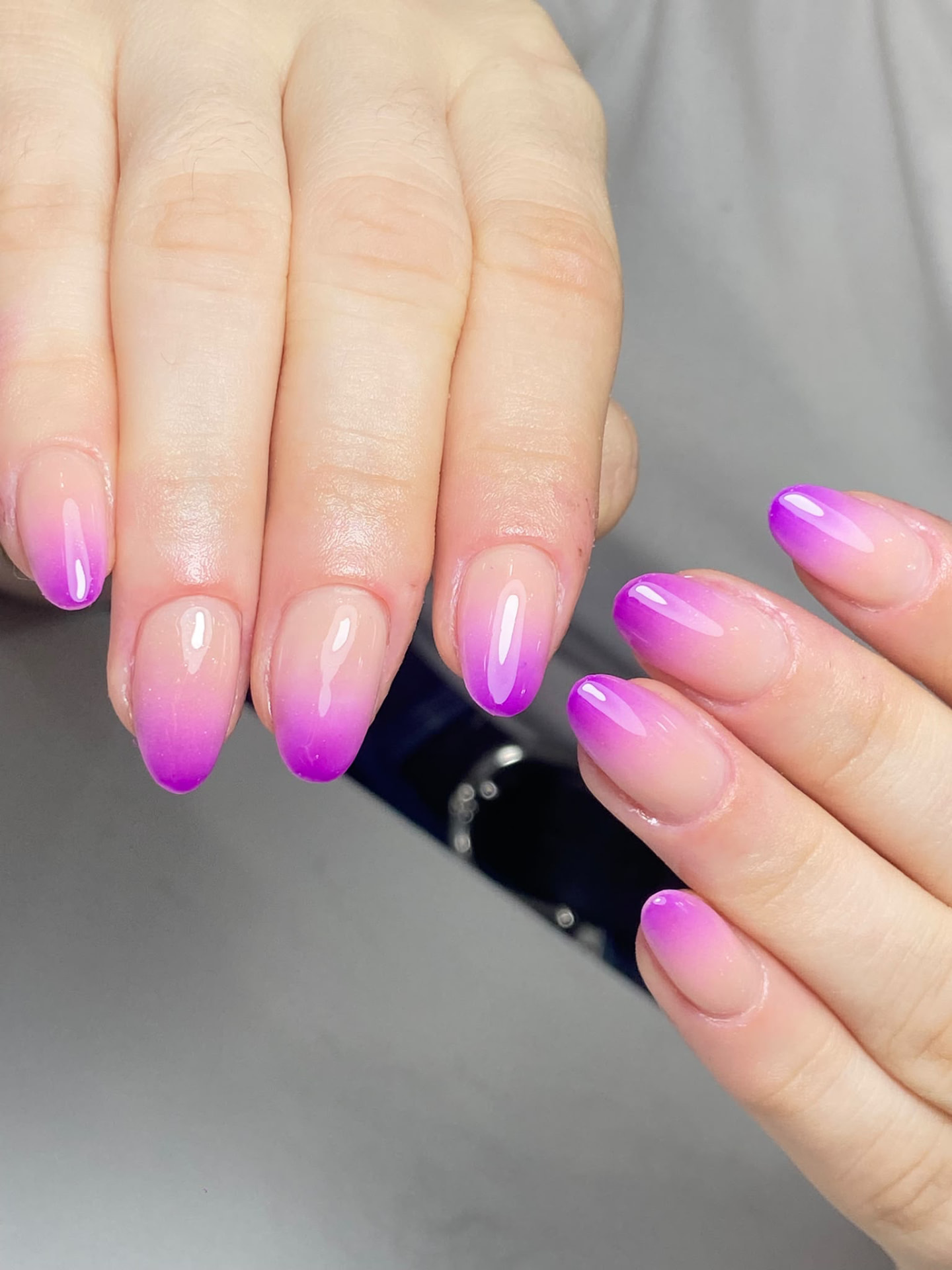 Manicura ovalada nude con degradado morado estilo baby boomer